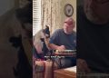 Dog Adorably Tilts Head to Man Tuning Banjo